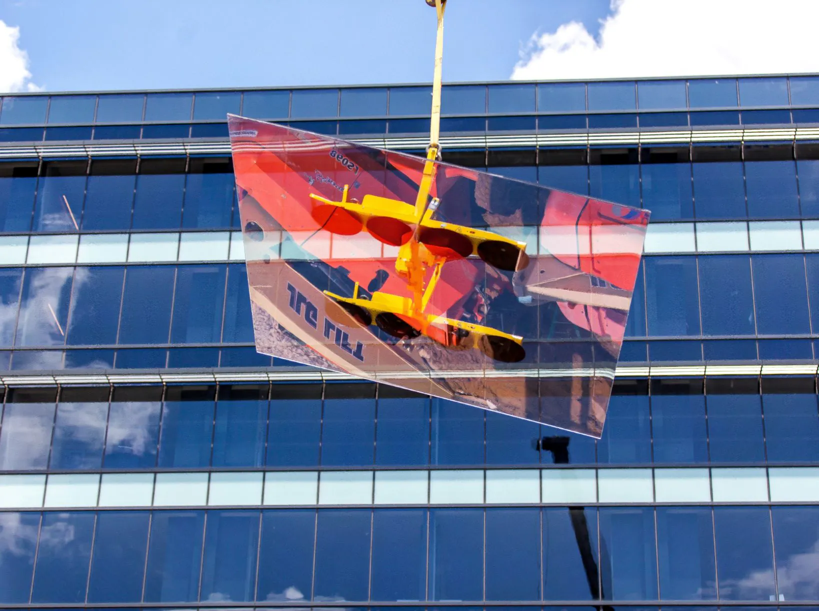 TSI Corporations team installing glass panels on a high-rise building